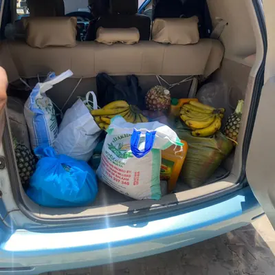 A car boot loaded with bananas, pineapples and sacks of food for Sintanaizer Foundation